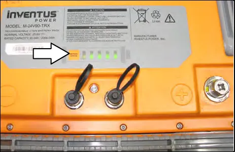 Power button and green battery discharge indicator lights on top of a lithium-ion battery
