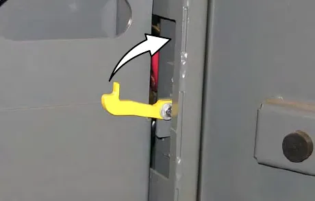 Rollout battery retainer handle being rotated toward the front of the battery compartment