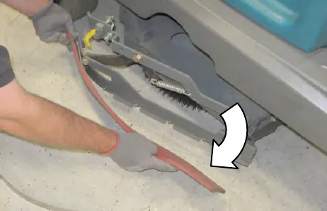 A person pulling the squeegee blade out of the side squeegee assembly, with an arrow showing the direction