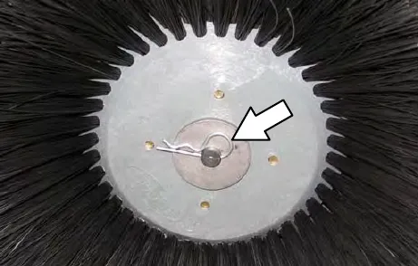 Underside of the disk brush hub with an arrow pointing to the cotter pin