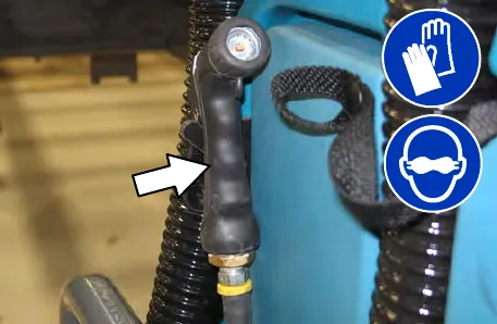 Spray nozzle pulled out from the back of the machine; wear gloves and eye protection