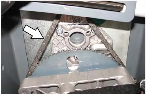 Steering gear chain above the front tire, with an arrow pointing to the chain
