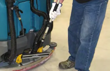 Vacuum hose being lifted off the rear squeegee