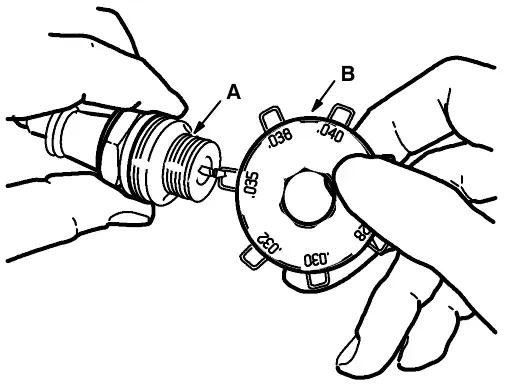 Gapping a spark plug: spark plug (A) and gapping tool (B)