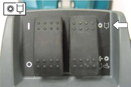 Handle control panel with an arrow pointing to the brush/solution position of the scrubbing mode switch
