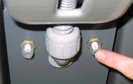 Finger pressing the 5 amp brush circuit breaker button on the side of the machine