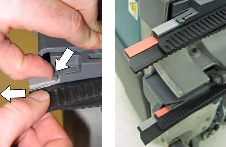 Lifting the blade retainer clip and pulling the blade from its channel; the red and gray blades in their channels