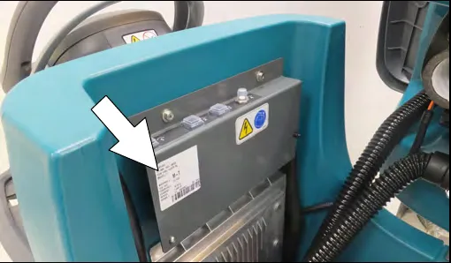 Photo of the serial number label on the T500, marked with an arrow, on the plate behind the operator handle area