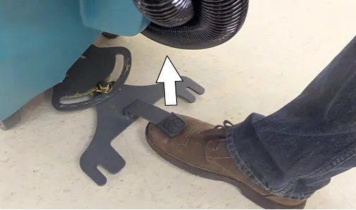Foot on the squeegee lift pedal raising the squeegee mount bracket