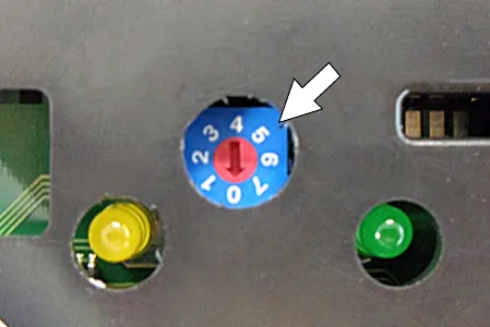 Turning the charger dial with a small standard screwdriver