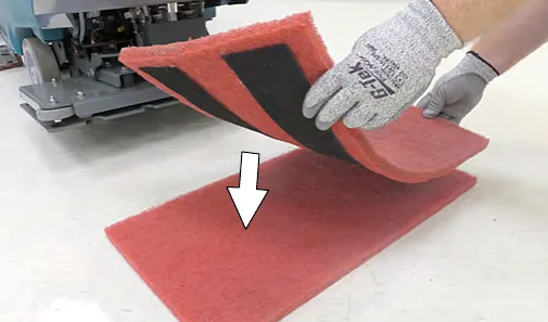 Attaching the backer pad, retaining strips facing downward, to the working pad