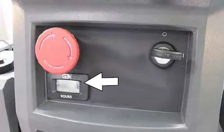 Hour meter on the control panel, marked by an arrow