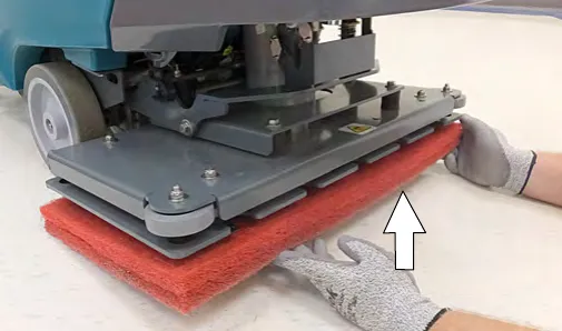 Attaching the two pads to the bottom of the orbital scrub head