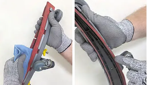 Wiping the squeegee blades clean and inspecting them