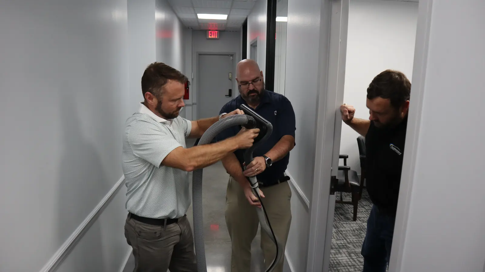 Carpet extractor wand cleaning a hallway carpet