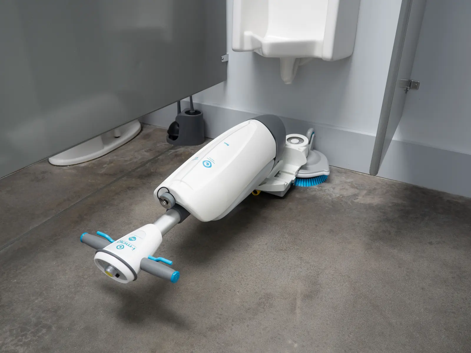 Tennant i-mop cleaning a restroom floor