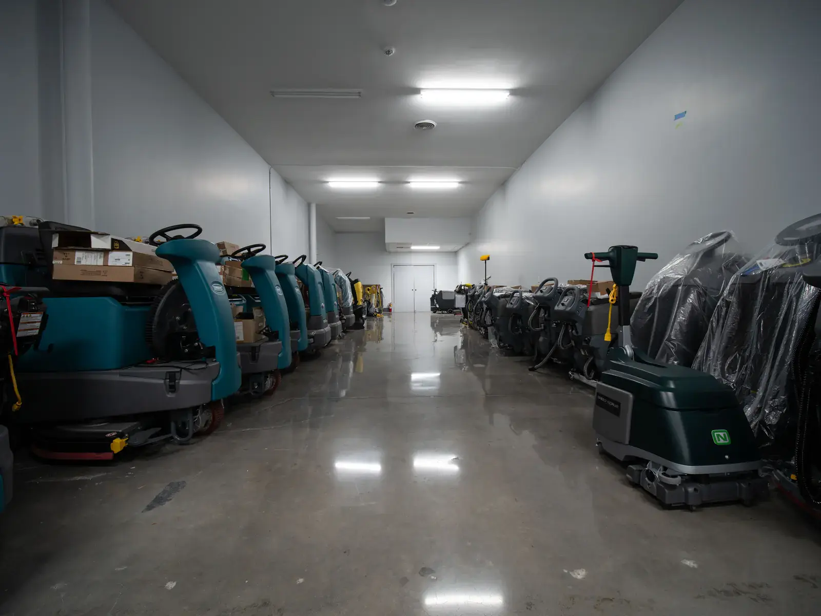 Row of floor scrubbers on a polished floor at SES
