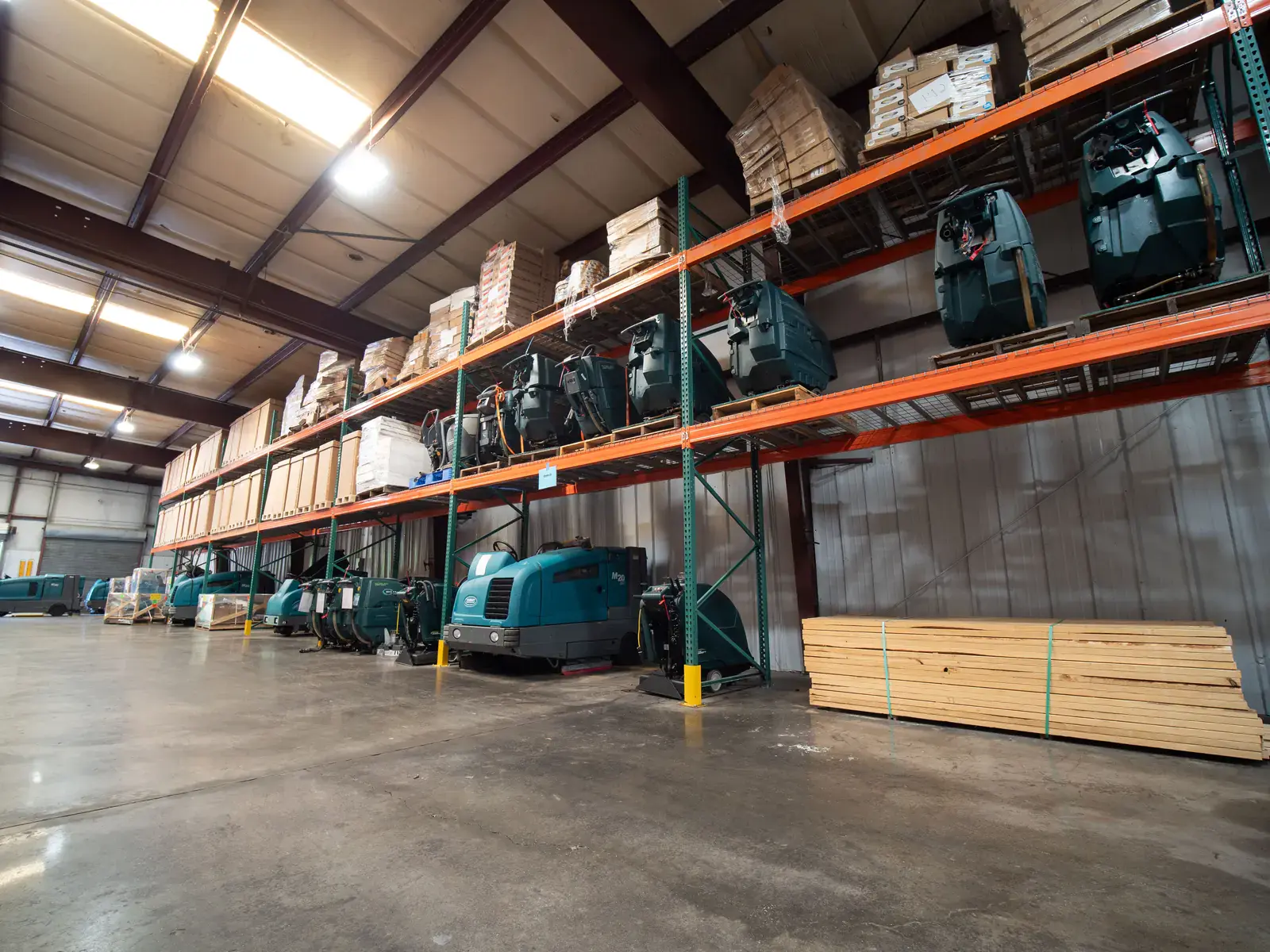 SES warehouse with floor cleaning machines on racking