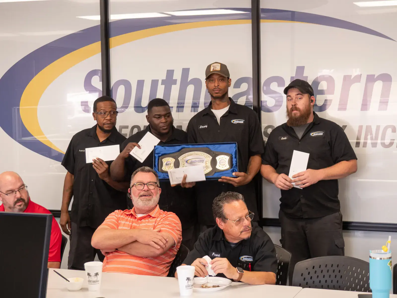SES technicians holding their Technician of the Month award