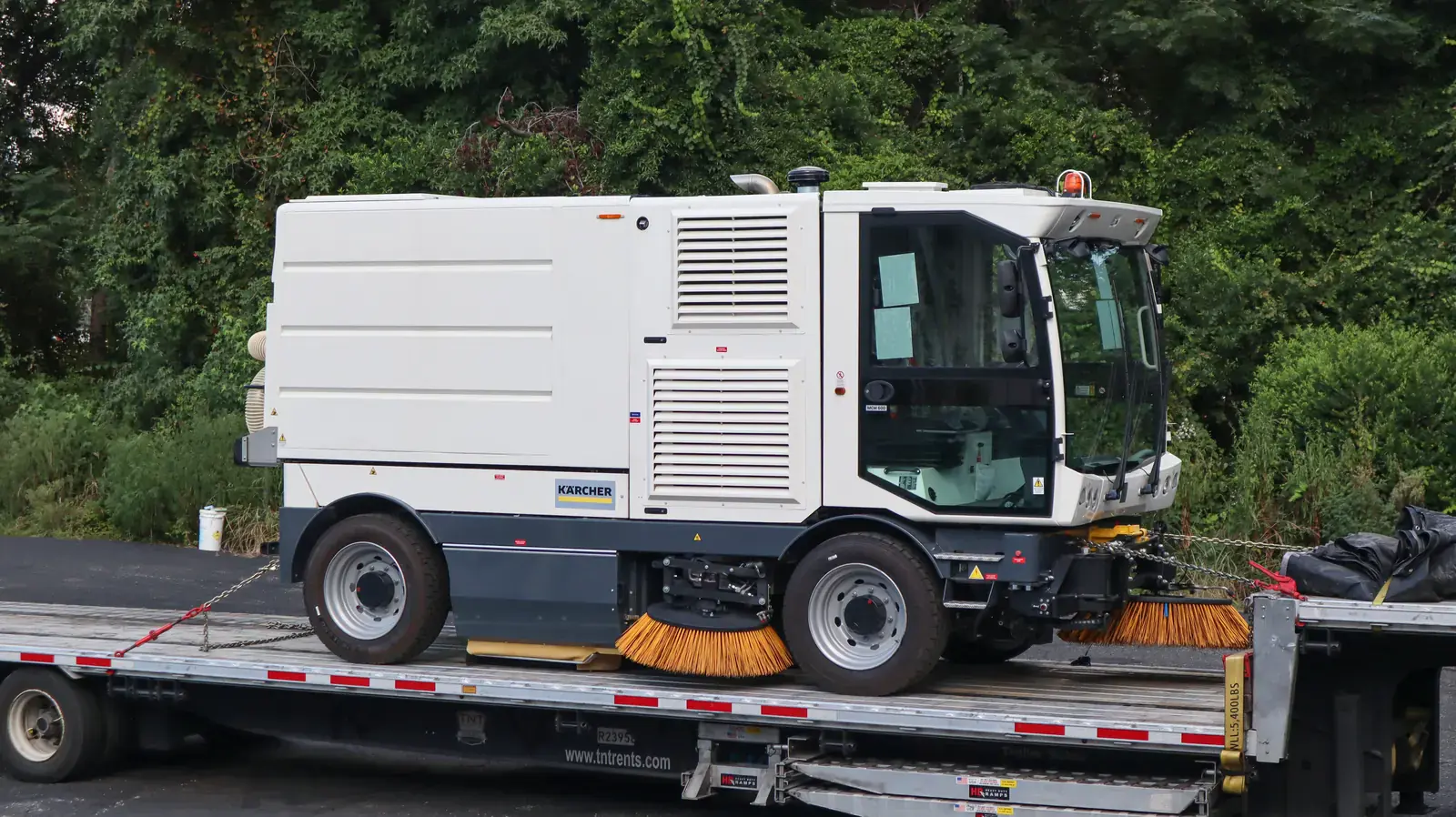 Karcher MCM 600 street sweeper loaded on a flatbed for transport